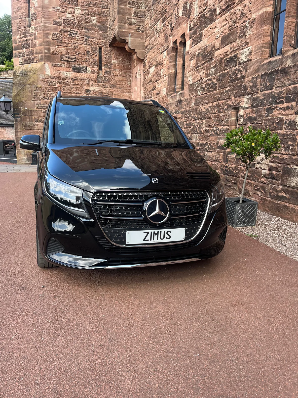 Mercedes-Benz V-Class parked beside a historic sandstone venue