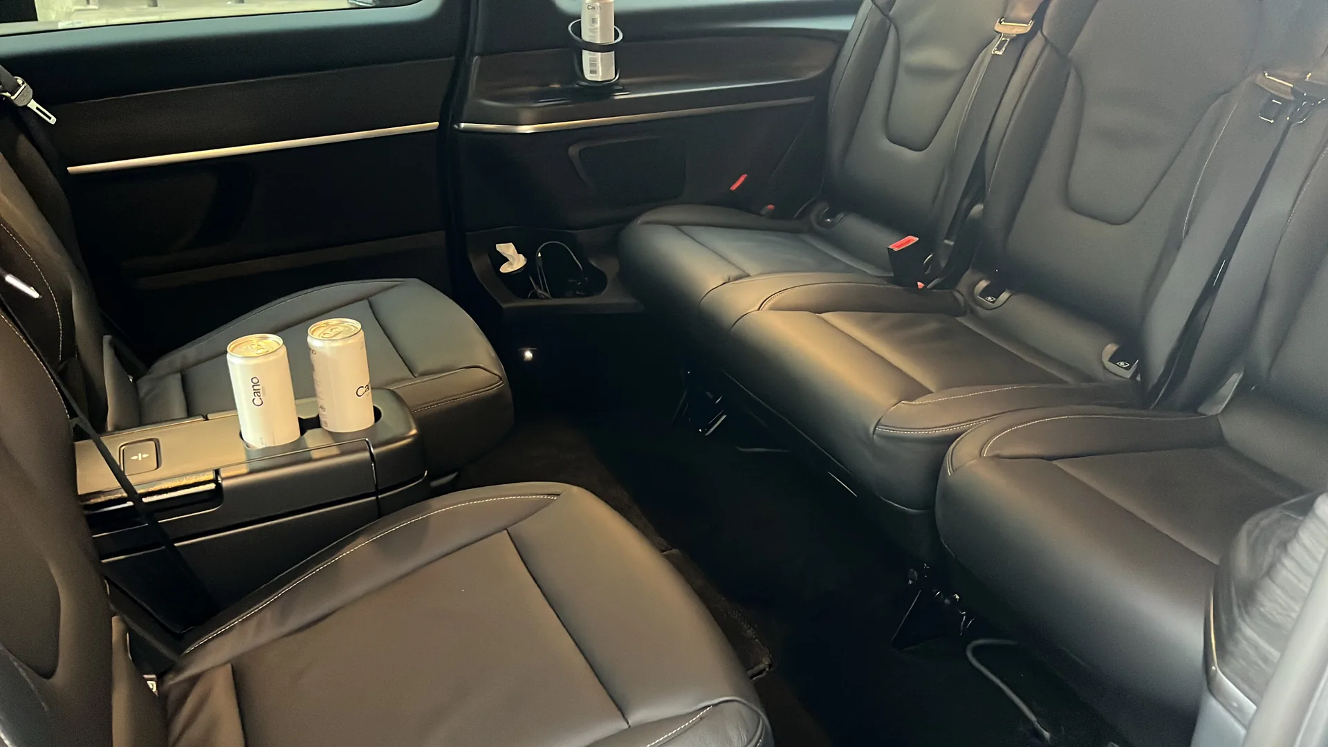 Rear cabin with black leather conference-style seating
